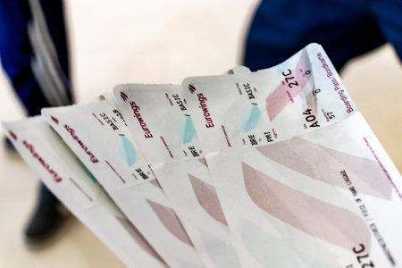Four Eurowings flight tickets in hand at Bremen Airport in Germany.のeditorial素材