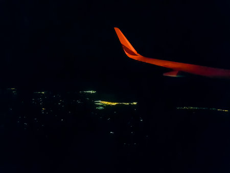 Flying over Spain Palma de Mallorca at night with view out of the airplane window.の写真素材
