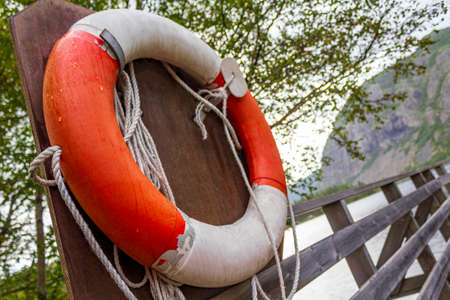 Orange lifebuoy by the lake VangsmjÃ¸se in Vang i Valdres Norway.の写真素材