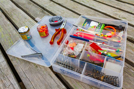 Fishing equipment with box on a wooden pier by the lake in Vang i Valdres, Norway.のeditorial素材