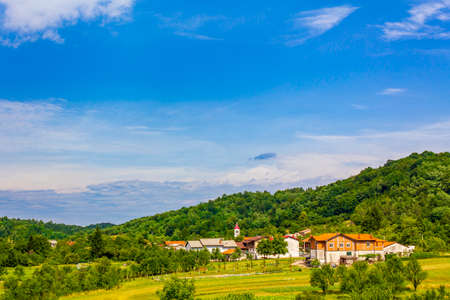 Wonderful mountain and forest landscape with an idyllic village in Slovenia.の写真素材
