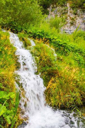 Plitvice Lakes National Park waterfall landscape water flows over stones in Croatia.の写真素材