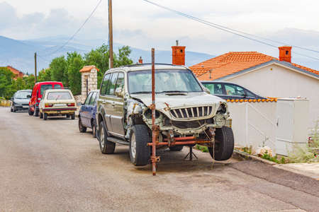 Old broken car parked on the side of the road in Novi Vinodolski Croatia.のeditorial素材
