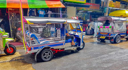 Typical colorful tuk tuks taxis driving people around in Bangkok Thailand.