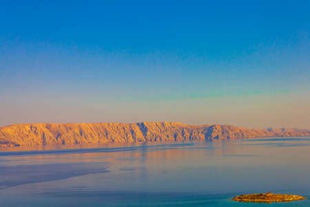 Colorful Novi Vinodolski at golden sunrise with turquoise water in croatia.の写真素材