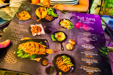 Colorful menu full of typical spicy Thai food in restaurant in Bangkok Thailand.のeditorial素材