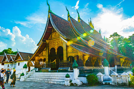 Luang Prabang Laos November 18, 2018 Sun rays and sunshine behind Wat Xieng Thong buddhist temple of the Golden City in Luang Prabang Laos.のeditorial素材