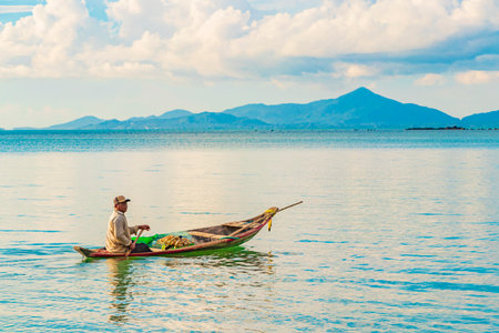 Surat Thani Thailand May 25, 2018 Fisherman with boat and Koh Pha-ngan landscape panorama on Koh Samui island in Thailand.のeditorial素材