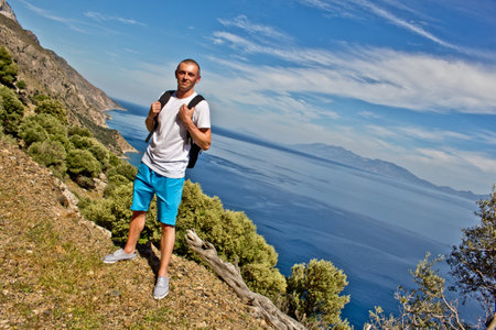 Young traveler hiker with natural coastal landscapes on Kos Island in Greece with mountains cliffs rocks turquoise blue beaches and waves.の写真素材