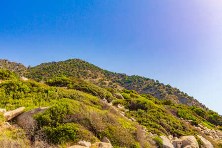 Natural coastal landscapes on Kos Island in Greece with mountains cliffs rocks turquoise blue beaches and waves.の写真素材