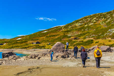 Hikers and tourists at the rough landscape of Vavatn lake and mountains during summer in Hemsedal Norway.のeditorial素材