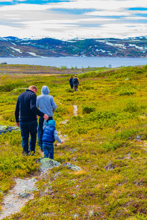 Viken Norway June 9th, 2016 Hikers and tourists at the rough landscape of Vavatn lake and mountains during summer in Hemsedal Norway.のeditorial素材