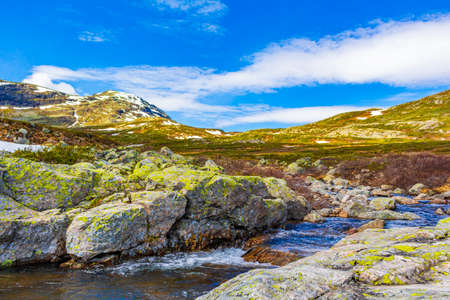 Beautiful Storebottane river by the vavatn lake with snow in the summer landscape in Hemsedal...