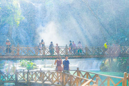 Luang Prabang Laos November 21, 2018 Water particles drip splash of turquoise Kuang Si waterfall with bridge in Luang Prabang Laos.のeditorial素材