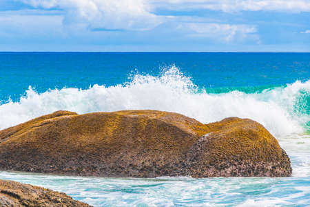 Strong wave hits huge rock at amazing Praia de Lopes Mendes beach on tropical island Ilha Grande in Angra dos Reis Rio de Janeiro Brazil.の写真素材