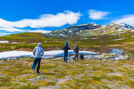 Viken Norway June 9th, 2016 People hikers are trekking by the river at landscape of Vavatn lake and mountains in Hemsedal Norway.のeditorial素材