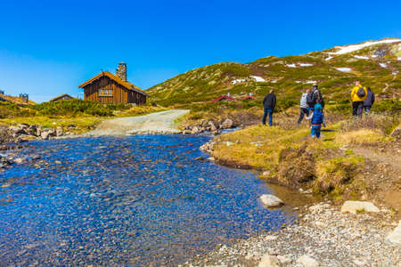 Viken Norway June 9th, 2016 People hikers are trekking by the river at landscape of Vavatn lake and mountains in Hemsedal Norway.のeditorial素材
