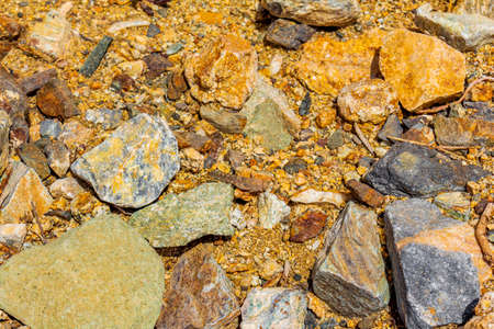 Beautiful golden orange or yellow colored boulders and rocks on the coast of Kos Island in Greece.の写真素材