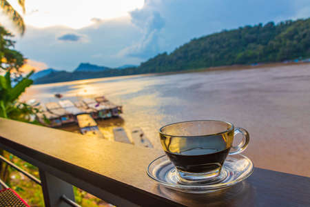 Black coffee crema in a transparent cup while sunset in Luang Prabang Laos.の写真素材