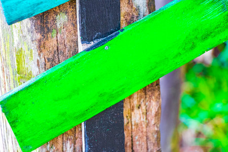 Colorful green plain directional wooden arrows on tropical island Ilha Grandの写真素材
