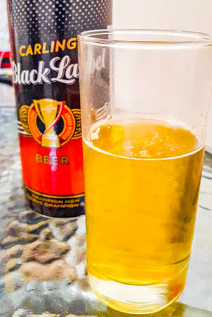 Carling Black Label beer can and glass on white background in Cape Town South Africa.のeditorial素材