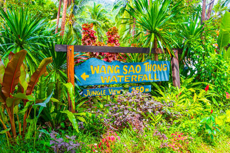 Wooden direction sign to the Wang Sao Thong Waterfall in tropical rainforest on Koh Samui in Surat Thani Thailand.のeditorial素材