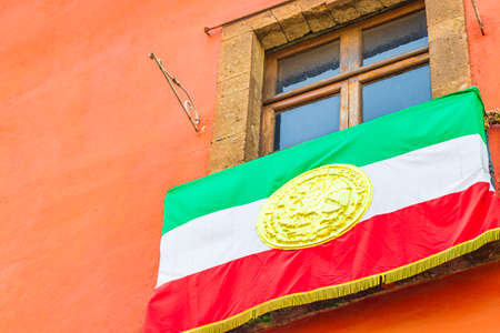 Mexican flag green white red hanging on building in the center of Mexico City in Mexico.の写真素材