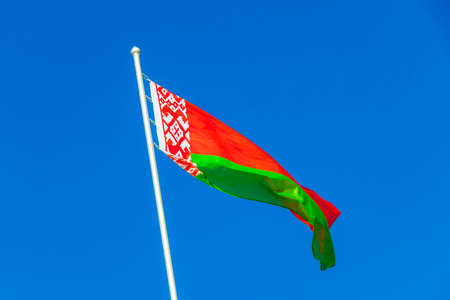 Flag of Belarus with blue sky and background belarusian flag red white green in Minsk Belarus.の写真素材