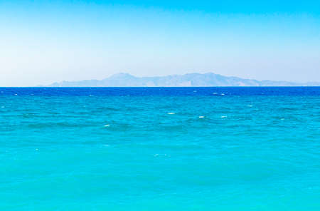 Kremasti beach with turquoise clear water and view to Turkey on Rhodes Greece.
