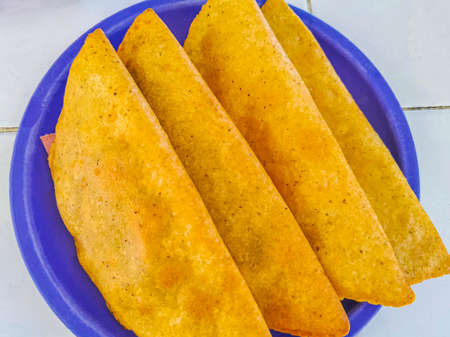 Mexican empanada on blue plate white background from Playa del Carmen in Mexico.の写真素材