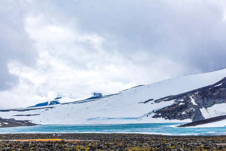 GaldhÃ¸piggen snow-covered in summer in Jotunheimen Lom in Norway is the largest and highest mountain in Norway and Scandinavia with 2469 meters.の写真素材