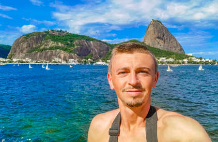 Tourist traveler takes selfie at the sugarloaf sugar loaf mountain PÃ£o de AÃ§ucar panorama view...