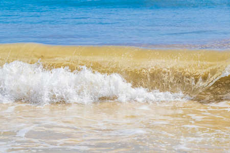 Tropical mexican beach with strong waves and clear turquoise blue water in Playa del Carmen Mexico.
