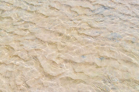 Pattern texture of sand and clear water at tropical mexican beach Punta Esmeralda in Playa del...