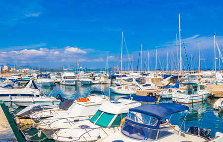 Mallorca Spain September 14, 2018 Promenade with boats yachts sailing boats in turquoise water in Can Picafort on Balearic island Mallorca in Spain.のeditorial素材
