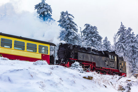 Steaming Brocken Railway locomotive in winter landscape at Brocken mountain in Harz mountains Wernigerode Saxony-Anhalt Germanyのeditorial素材