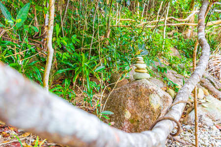 Stapled stacked stones in the beautiful amazing coast line and beach landscape panorama view of the Lam ru Lamru National Park in Khao Lak Phang-nga Thailand.の写真素材