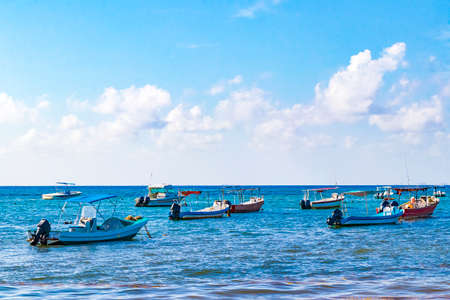 Boats and yachts at tropical mexican beach panorama view with turquoise blue water from Playa 88 and Punta Esmeralda in Playa del Carmen Mexico.の写真素材
