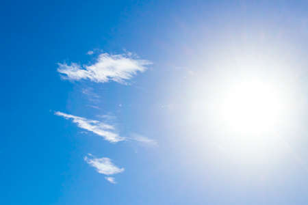 Blue sky with shining sun and chemical clouds chemical sky and chemtrails on sunny day in Playa del Carmen Mexico.の写真素材