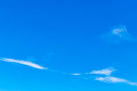 Blue sky with chemical clouds chemical sky and chemtrails on sunny day in Playa del Carmen Mexico.