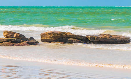 Panorama landscape view on beautiful Holbox island sandbank and beach with waves turquoise water boulders rocks and stones in Quintana Roo Mexico.の写真素材