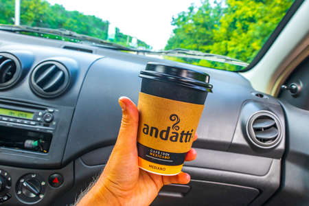 Playa del Carmen Mexico December 21, 2021 Mexican andatti coffee from Oxxo holding in the car while...