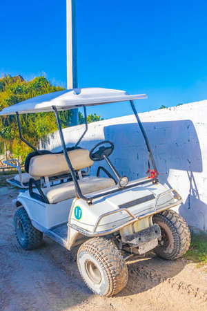 Golf cart buggy cars carts on muddy street in the village on Holbox island Mexico.の写真素材