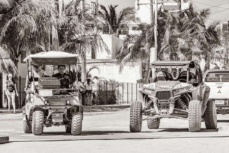 Holbox Mexico December 21, 2021 Black and white picture of a golf cart and buggy cars carts on muddy street in the village on Holbox island Mexico.のeditorial素材