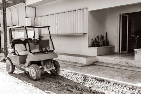 Black and white picture of a golf cart buggy cars carts on muddy street in the village on Holbox island Mexico.の写真素材