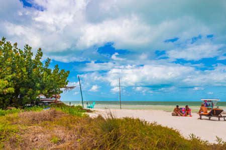 Holbox Mexico December 22, 2021 Panorama landscape view on beautiful Holbox island sandbank and beach with huts palapa and sun loungers and blue sky in Quintana Roo Mexico.のeditorial素材