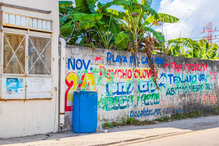 Playa del Carmen Mexico February 02, 2022 Typical street road and cityscape with cars and buildings and wall paintings of Luis Donaldo Colosio Playa del Carmen in Mexico.のeditorial素材