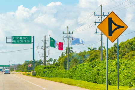 Broken damaged green turquoise road sign at the highway in the city of Playa del Carmen to Tulum Quintana Roo Mexico.の写真素材