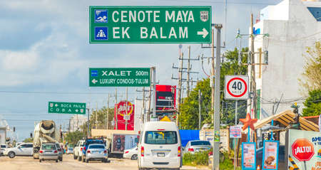 Tulum Mexico February 02, 2022 Driving thru typical street road and cityscape with cars traffic bars...