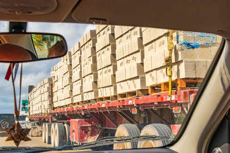 Tulum Mexico February 02, 2022 Trucks dump truck and other industrial vehicles on typical street road and cityscape in Tulum in Mexico.のeditorial素材